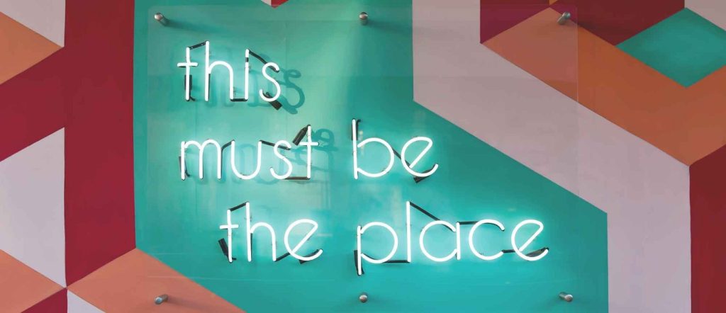 A neon sign "This must be the place""